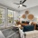 Apartments for Rent in Land O' Lakes, FL - Everwell at Bexley - Living Room with Wood-Style Flooring, Area Rug, Leather Couch, White Armchair, Glass Side Table with Lamp, Round Multi-Level Coffee Table, Storage Cabinet, Ceiling Fan, Oversized Double-Pane 